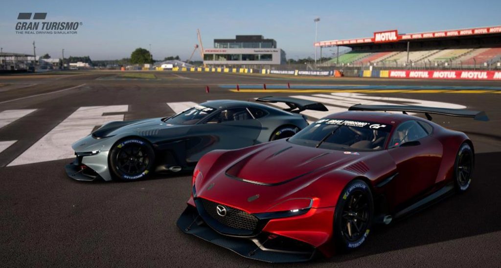 Photo of 2 race cars, one red, one silver on a race track