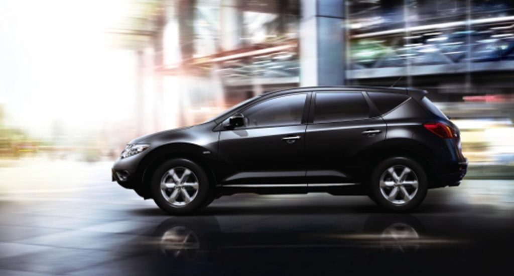 Image of a black nissan SUV speeding on a highway