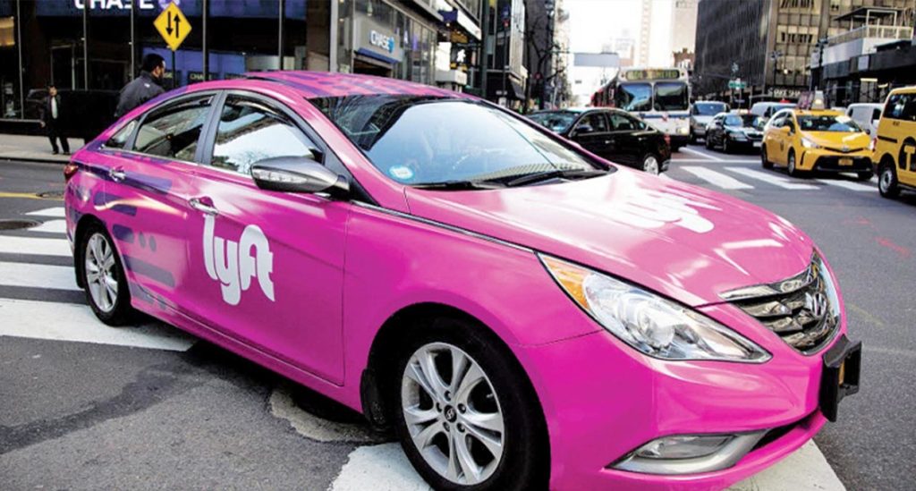 pink-colored Nissan Electric Vehicle