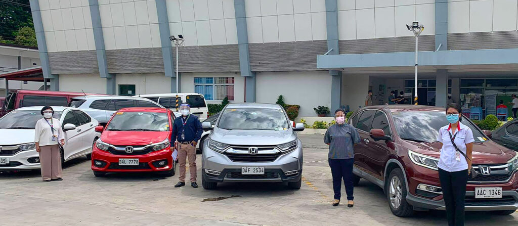 Toyota representatives standing beside toyota vehicles