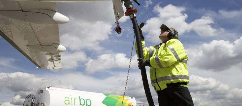 man inspecting airplane wing
